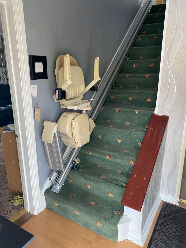 Stairlift service with hinged rail
